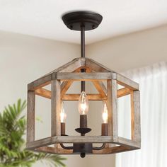 a wooden light fixture hanging from the ceiling