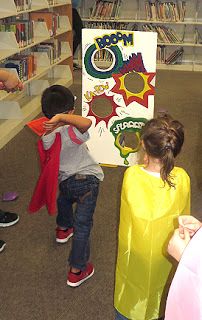 several children are standing in front of a book shelf and looking at books on the shelves