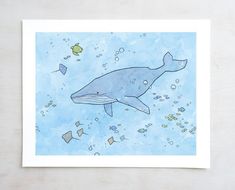 a whale is swimming in the ocean with fish and bubbles on it's side