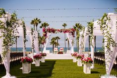 an outdoor ceremony set up with flowers and greenery