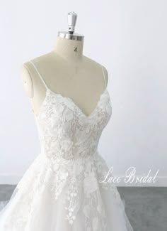 a white wedding dress on a mannequin with the words lace bridal above it