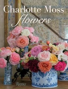 the cover of charlotte moss's flowers, featuring pink and orange flowers in blue vases