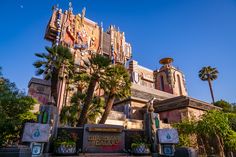 the entrance to disneyland's hollywood studios with palm trees and blue sky in the background