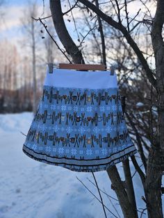 a skirt hanging from a tree in the snow