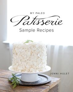 a white cake sitting on top of a wooden table next to a window with the words, my paleo patissee sample recipes