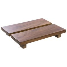 two wooden trays sitting on top of each other