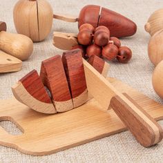 wooden toys are arranged on the floor with apples and other woodworking items around them