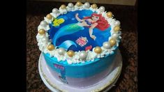 a birthday cake decorated with an image of the little mermaid