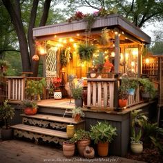 a deck with potted plants and lights on it