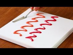 someone is writing the word happy on a piece of white paper with red crayons