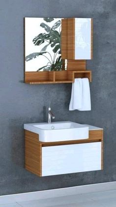 a white sink sitting under a mirror in a bathroom