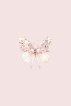 a pink and white butterfly with flowers on it's wings, against a light pink background