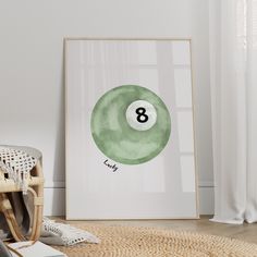 a green pool ball with the number eight on it in front of a white wall