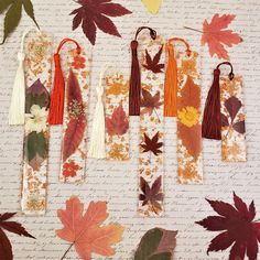 autumn leaves and tassels laid out on a sheet of paper