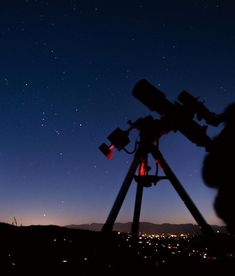 a person looking at the stars through a telescope