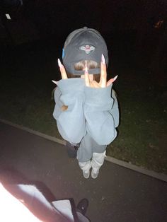 a person wearing an elephant costume with their hands in the air