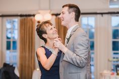 a man and woman dancing together at a wedding