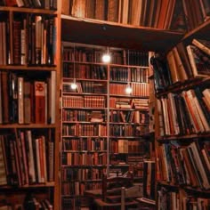 a bookshelf filled with lots of books next to a wall full of books