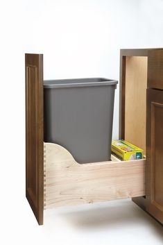 The Rev-A-Shelf 50-Quart Pullout Garbage Can for the kitchen cabinet is the ideal solution for your kitchen waste needs. Conveniently store your trash bins tucked away in your drawers so you can maintain your kitchen's lovely appearance. This under sink trash can is designed for 15-inch cabinets with a 12-inch opening. It's constructed of a dovetail frame with a satin finish. It can fit single 50-quart trash bin containers. This Rev-A-Shelf pullout trash can model includes (1) 50-quart container Wood Trash Can, Pull Out Trash Cans, Trash Containers, Rev A Shelf, Waste Container, Recycling Center, Kitchen Waste, Trash And Recycling Bin, Kitchen Tops