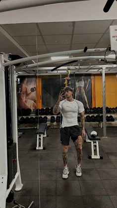 a man standing in the middle of a gym