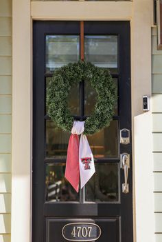 a wreath on the front door of a house