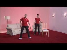 two women in red shirts are playing with a wii mote on a pink carpet