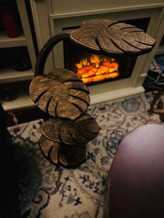 a fire place that is in the middle of a room with a rug on it