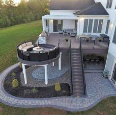 an aerial view of a house with a patio and fire pit in the middle of it