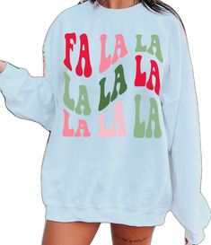 a woman wearing a sweatshirt with the words fala la la la written on it