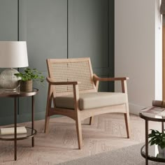 a living room filled with furniture and a lamp on top of a wooden table next to a window