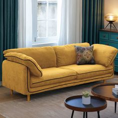 a living room scene with focus on the couch and coffee table in the foreground