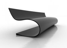 a black curved object on a white surface