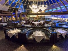 a dining room with chandeliers and tables in it