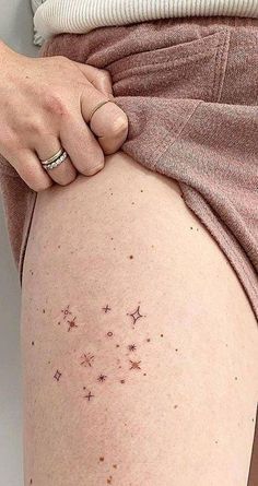 a woman's thigh with small stars on it