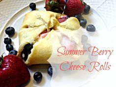 a close up of a plate of food with berries on it and the words summer berry cheese rolls