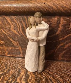 a ceramic figurine of two people hugging each other