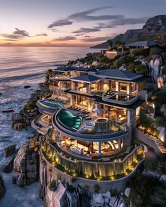 an aerial view of a house on the beach at night with its lights turned on