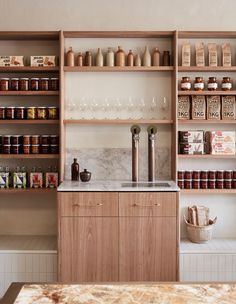 a kitchen with lots of shelves filled with spices