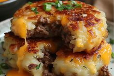 cheeseburger patties stacked on top of each other with melted cheese and green onions