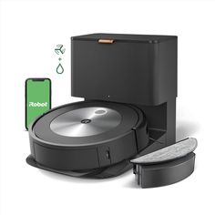 the robot vacuum is next to an iphone and other items that include a cell phone