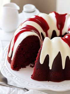 a red velvet bunt cake with white icing and drizzled on top