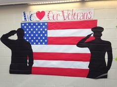 two soldiers saluting in front of an american flag with we love our veterans written on it