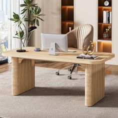 an office desk with a computer on it in front of a bookcase and potted plant