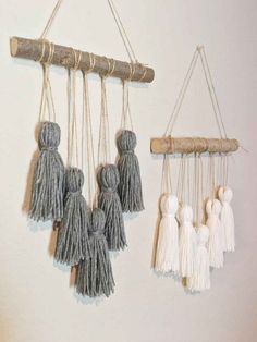 three macrame hangings with tassels attached to each other on a wall