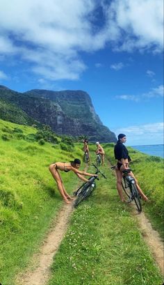 some people riding bikes on a grassy hill