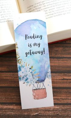 a bookmark with the words reading is my getaway on it