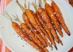 cooked carrots on a white plate with brown sauce