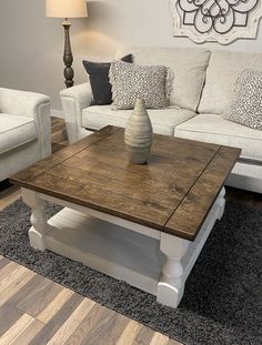 a living room with two couches, a coffee table and a lamp in it