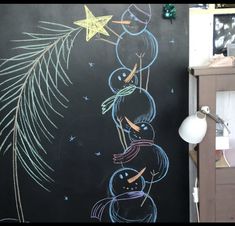 a chalk board with snowmen and stars on it