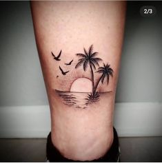 a small palm tree on the side of a woman's leg with birds flying over it